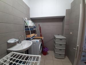 a bathroom with a sink and a washing machine at Symbligates rocks in Kalymnos +31 photos
