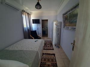 a small bedroom with a bed and a hallway at Symbligates rocks in Kalymnos