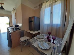 a kitchen with a table with two plates on it at Symbligates rocks in Kalymnos