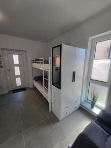 a bedroom with a bunk bed and a white cabinet at Ferienwohnung Esen EG in Günzburg