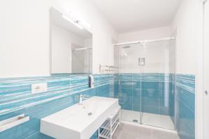 un bagno con lavandino e doccia in vetro di B&B S'Unda Jara ad Alghero