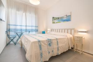 Postel nebo postele na pokoji v ubytování B&B S'Unda Jara