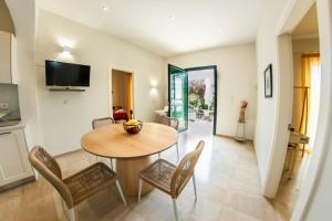 a kitchen and dining room with a table and chairs at Taxi Driver Apartments in Paleokastritsa