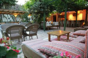a patio with tables and chairs and a table and chairs at Dardanos Hotel in Patara