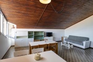 a kitchen and living room with a couch and a table at Alloggio vista mare in San Bartolomeo al Mare