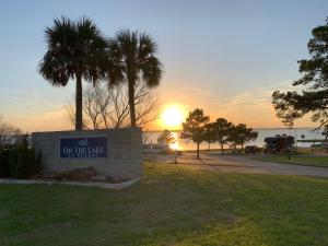 a sign with the sun setting in a park at On The Lake #116 in Onalaska