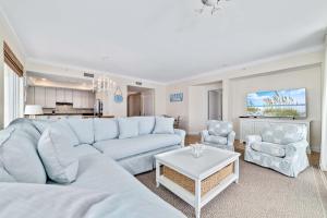 un soggiorno con un divano bianco e 2 sedie di Indigo Unit 1406e a Pensacola