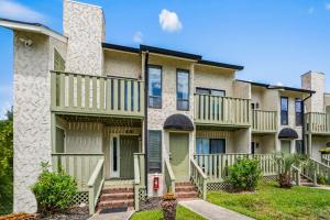 an apartment building with balconies and a yard at Brandywine Unit 203 in Myrtle Beach