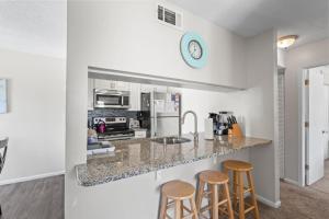 a kitchen with a counter and two stools at Brandywine Unit 203 in Myrtle Beach