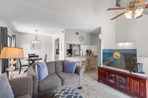 a living room with a couch and a flat screen tv at Brandywine Unit 203 in Myrtle Beach +23 photos