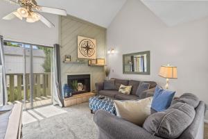 a living room with a couch and a fireplace at Brandywine Unit 203 in Myrtle Beach