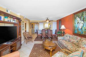 a living room with a couch and a flat screen tv at Driftwood Towers 4B in Gulf Shores +23 photos