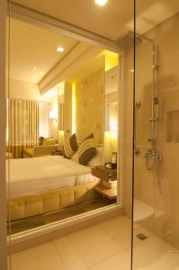a hotel room with a bed and a shower at Hotel Benilde Maison De La Salle in Manila