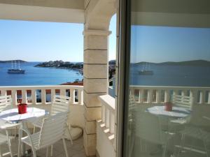 a balcony with two tables and a view of the ocean at Villa Mandina in Sevid