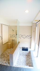 a bathroom with a shower with a glass wall at Lan Yang Resort Four Seasons in Dongshan