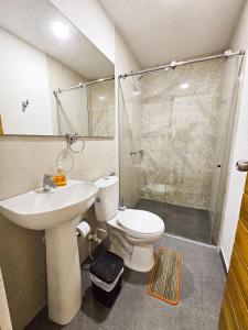 a bathroom with a toilet and a sink and a shower at Casa Playa Boquilla in Cartagena de Indias