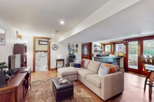 a living room with a couch and a kitchen at Volunteer Park Vacation in Seattle