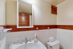 a bathroom with a sink and a mirror and a toilet at Volunteer Park Vacation in Seattle +11 photos