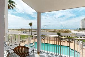 a balcony with a view of a pool and the ocean at Grand Beach Resort 209 in Gulf Shores