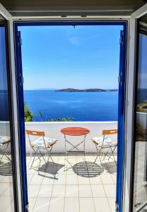 a view of the ocean from the balcony of a house at Cycladic Horizon Island Villa By Hostandros in Batsi