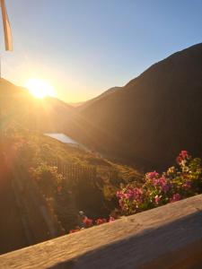 a view of the sun setting over the mountains at Finailhof in Madonna