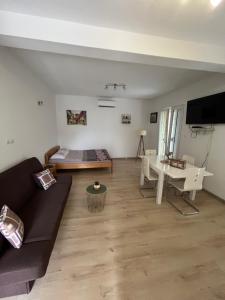 a living room with a couch and a table at Apartman Iskra in Bijela