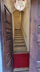 a hallway with stairs and a door with a chandelier at Albergo Trieste Boves - Ricetto Suite in Boves