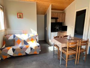 a living room with a table and a couch at Camping La Tourelle in Plémy +35 photos