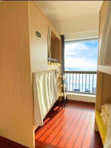 Voodi või voodid majutusasutuse Yiweidu Youth Apartment toas
