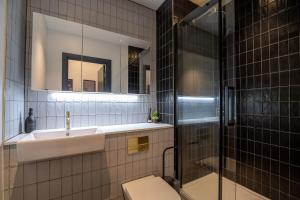 a bathroom with a toilet and a sink and a shower at Bauhaus by The Heim Residences in Manchester
