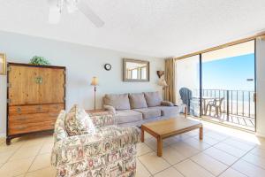 a living room with a couch and a table at Gulf House 202 in Gulf Shores +22 photos