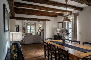 a kitchen and dining room with a wooden table and chairs at Villa Rovere Orbani in Orbani