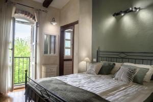 a bedroom with a large bed and a window at Villa Rovere Orbani in Orbani +28 photos