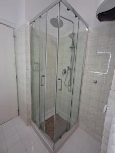 a shower with a glass door in a bathroom at cà venice tour vaction in Mestre +21 photos
