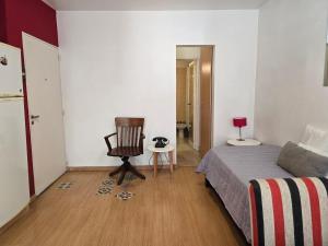 a bedroom with a bed and a chair in it at Luz Urbana BA Studio in Buenos Aires +1 photo