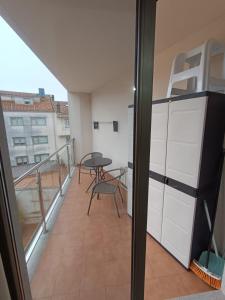 a balcony with a table and a table at Estudio Centro A Guarda in A Guarda