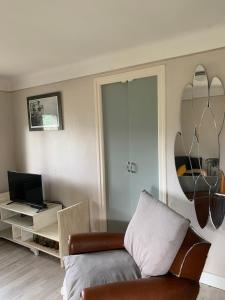 a living room with a couch and a table with a laptop at Les Meublés de la Corniche in Argelès-sur-Mer +15 photos