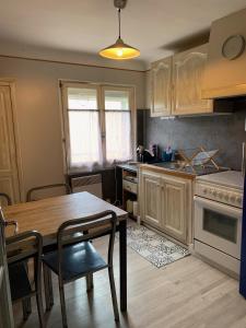 a kitchen with a table and a dining room at Les Meublés de la Corniche in Argelès-sur-Mer