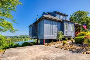 a blue house with a river in the background at Lake View Cabin Incredible Panoramic Views, Spa in Sevierville