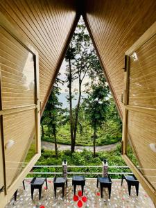 a view from the inside of a room with tables and chairs at The Tea Tribe Stay in Sonāda +9 photos