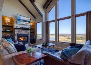a living room with a couch and a fireplace at Lake View Cabin Incredible Panoramic Views, Spa in Sevierville
