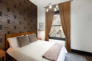 una camera da letto con un letto bianco e una finestra di The Block Basic - Queen a Bisbee
