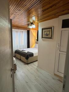 a bedroom with a bed and a wooden ceiling at Ali's Pension ada alis in Egirdir +81 photos