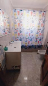 a bathroom with a sink and a shower curtain at Casa Campanilla Valle De Abdalajis in Valle de Abdalagís