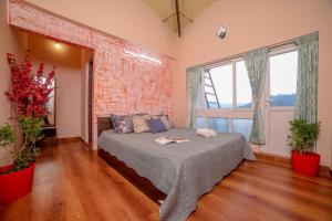 a bedroom with a bed and a large window at Spring Fields in Coimbatore