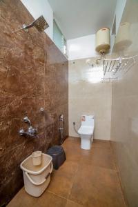 a bathroom with a toilet and a sink at Spring Fields in Coimbatore