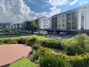 a garden in front of a building with a park at Greenlee Lifestyle Apartment- 2 Bedroom in Sandton