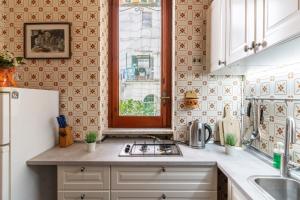 a kitchen with a sink and a refrigerator at CristallPont AmalfiDay in Atrani