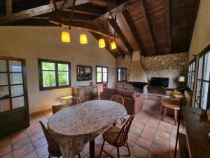 a living room with a table and a couch at L'AMAGATALL DEL MONTNEGRE in Villalba Saserra