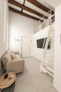 a living room with a staircase and a couch at Santa Caterina Apartment in Varazze